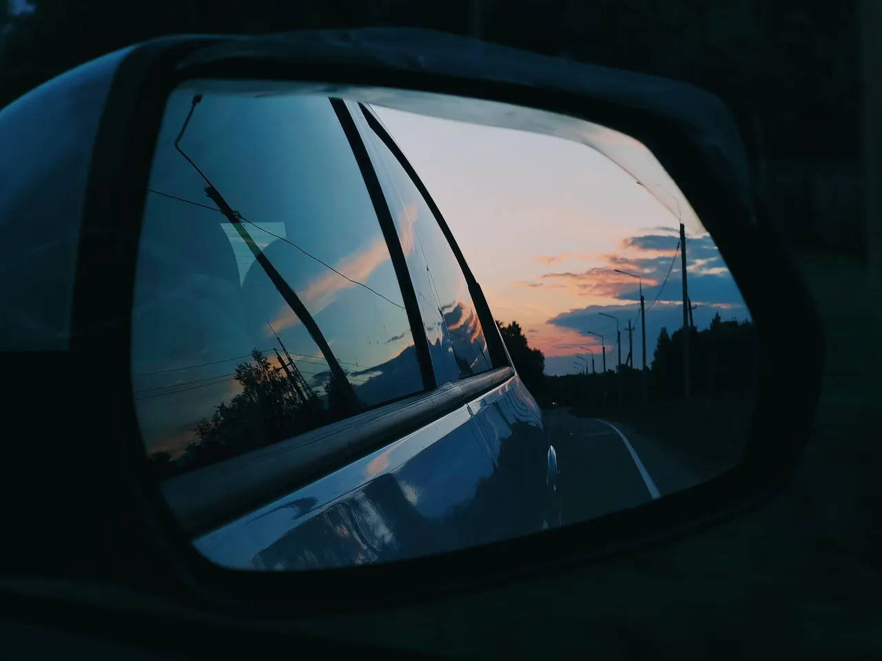 Car Mirror Reflection at Sunset on Moscow Road